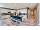 Spacious kitchen features a large center island with seating, white cabinetry, and stainless steel appliances at 3907 S 75Th Dr, Phoenix, AZ 85043