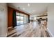 Open concept living room with sliding glass doors and seamless flow into a modern kitchen at 3907 S 75Th Dr, Phoenix, AZ 85043