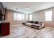 Comfortable living room featuring a cozy sectional sofa, modern ceiling fan, and a wall-mounted television at 3907 S 75Th Dr, Phoenix, AZ 85043
