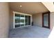 A covered patio space perfect for outdoor entertaining, accessible through sliding glass doors at 3907 S 75Th Dr, Phoenix, AZ 85043