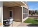 Cozy covered back patio area with outdoor seating and an adjacent turf area at 429 N San Ricardo N Trl, Casa Grande, AZ 85194