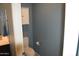 Cozy half-bathroom features a toilet and vanity sink with a storage cabinet mounted above the toilet at 429 N San Ricardo N Trl, Casa Grande, AZ 85194