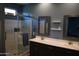 Modern bathroom featuring double sinks, framed mirrors, and a glass-enclosed shower with white subway tile at 429 N San Ricardo N Trl, Casa Grande, AZ 85194