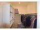 Walk-in closet with built-in shelving and hanging rods offers ample storage and organization space at 429 N San Ricardo N Trl, Casa Grande, AZ 85194