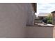 Side exterior showing the well maintained texture, stone trim, and a glimpse of backyard at 429 N San Ricardo N Trl, Casa Grande, AZ 85194