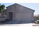Traditional home with a two-car garage and desert landscaping at 429 N San Ricardo N Trl, Casa Grande, AZ 85194
