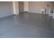 Clean garage with epoxy flooring, utility sink, white cabinets and neutral color walls at 429 N San Ricardo N Trl, Casa Grande, AZ 85194