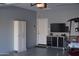 Epoxy flooring, white storage cabinets, utility sink, tool chest, and a tv in this garage at 429 N San Ricardo N Trl, Casa Grande, AZ 85194