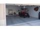 Clean garage features epoxy flooring, custom cabinets, tv, and golf cart at 429 N San Ricardo N Trl, Casa Grande, AZ 85194