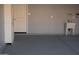 Garage with epoxy flooring, utility sink, access door, and white cabinets at 429 N San Ricardo N Trl, Casa Grande, AZ 85194