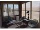 Enclosed sunroom with multiple windows and seating with accent pillows, offering an inviting space to relax at 429 N San Ricardo N Trl, Casa Grande, AZ 85194