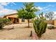 Backyard featuring low-maintenance desert landscaping, a patio, and a mature tree at 43142 N Outer Bank Dr, Anthem, AZ 85086