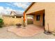 Backyard patio with red pavers, a fire pit, and low-maintenance desert landscaping at 43142 N Outer Bank Dr, Anthem, AZ 85086