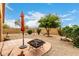 Tranquil backyard featuring low-maintenance landscaping, a patio, and a fire pit at 43142 N Outer Bank Dr, Anthem, AZ 85086