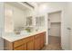 Bathroom with dual sinks and a walk-in closet at 43142 N Outer Bank Dr, Anthem, AZ 85086