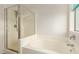 Clean bathroom with glass-enclosed shower and separate bathtub at 43142 N Outer Bank Dr, Anthem, AZ 85086