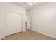 A tidy bedroom with tiled floor, built-in closet with sliding doors, and a white door at 43142 N Outer Bank Dr, Anthem, AZ 85086