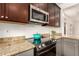 Updated kitchen with granite countertops, stainless steel microwave and glass cooktop stove at 43142 N Outer Bank Dr, Anthem, AZ 85086