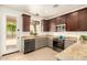 Well-lit kitchen featuring stainless steel appliances, granite counters and access to back yard at 43142 N Outer Bank Dr, Anthem, AZ 85086