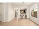 Open living room leading to kitchen and dining area featuring tile floors and neutral paint at 43142 N Outer Bank Dr, Anthem, AZ 85086