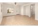 Open living room with tile floors features a front door and access to the bedrooms at 43142 N Outer Bank Dr, Anthem, AZ 85086