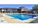 Community pool with clear blue water, lap lanes, diving board, and surrounding deck with lounge chairs at 43142 N Outer Bank Dr, Anthem, AZ 85086