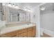 Bathroom vanity with large mirror, cabinets and a view of the bathtub-shower combo at 4554 E Paradise Village Pkwy # 161, Phoenix, AZ 85032