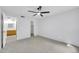 Bedroom with neutral carpet, ceiling fan and view to bathroom and closet at 4554 E Paradise Village Pkwy # 161, Phoenix, AZ 85032