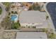 Backyard view with a pool, covered patio, desert landscape, and neighboring house at 4864 E Eden Dr, Cave Creek, AZ 85331