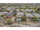 Aerial view of neighborhood near golf course, featuring homes with pools at 4864 E Eden Dr, Cave Creek, AZ 85331