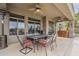 A covered patio with an outdoor dining area, ceiling fans, and desert landscaping at 4864 E Eden Dr, Cave Creek, AZ 85331