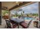 A covered patio area with dining, grill and a swimming pool at 4864 E Eden Dr, Cave Creek, AZ 85331