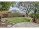 Artificial turf in backyard with decorative stone, lighting, and patio at 4864 E Eden Dr, Cave Creek, AZ 85331
