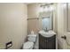 Half bathroom with a wood vanity, white toilet and light colored walls at 4864 E Eden Dr, Cave Creek, AZ 85331