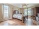 Elegant bedroom featuring a four-poster bed, wooden floors, and abundant natural light, creating a luxurious space at 4864 E Eden Dr, Cave Creek, AZ 85331