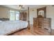 Spacious bedroom with a traditional four-poster bed, rich wood furniture, and expansive windows for natural light at 4864 E Eden Dr, Cave Creek, AZ 85331