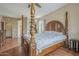 Inviting bedroom featuring a grand four-poster bed and hardwood floors, blending comfort and timeless elegance at 4864 E Eden Dr, Cave Creek, AZ 85331