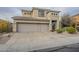 The facade of a two-story home with a three-car garage and xeriscaped front yard at 4864 E Eden Dr, Cave Creek, AZ 85331
