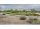 View of a well-manicured golf course featuring lush green, desert landscaping, and a concrete path at 4864 E Eden Dr, Cave Creek, AZ 85331