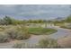 Beautiful golf course view featuring lush green fairways, desert landscaping, and mountain views in the distance at 4864 E Eden Dr, Cave Creek, AZ 85331