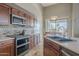 Well-appointed kitchen featuring stainless steel appliances, granite counters, and a cozy breakfast nook at 4864 E Eden Dr, Cave Creek, AZ 85331