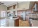 Modern kitchen featuring an island with bar seating, stainless steel appliances, and custom cabinetry at 4864 E Eden Dr, Cave Creek, AZ 85331