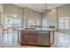 Large kitchen island with dual sinks, bar seating, and open view to the dining and living area at 4864 E Eden Dr, Cave Creek, AZ 85331