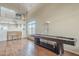 Spacious living area featuring a shuffleboard table, hardwood floors, and natural light at 4864 E Eden Dr, Cave Creek, AZ 85331