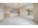 Spacious living room features neutral carpet, ceiling fan, and large mirror at 4864 E Eden Dr, Cave Creek, AZ 85331