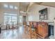 Open-concept living area with a bar, stools, hardwood floors, and large windows at 4864 E Eden Dr, Cave Creek, AZ 85331