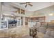 Open-concept living room featuring travertine flooring, a ceiling fan, and neutral color palette at 4864 E Eden Dr, Cave Creek, AZ 85331