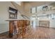 Cozy living room with a bar, seating, hardwood floors, and a view into an open kitchen at 4864 E Eden Dr, Cave Creek, AZ 85331