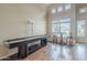Bright and airy living room with a shuffleboard table, hardwood floors, and large windows at 4864 E Eden Dr, Cave Creek, AZ 85331