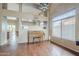 Bright living room showcasing a piano, vaulted ceiling, hardwood floors, and natural light at 4864 E Eden Dr, Cave Creek, AZ 85331